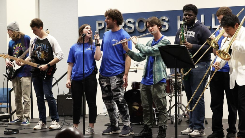 A group of people singing on a stage