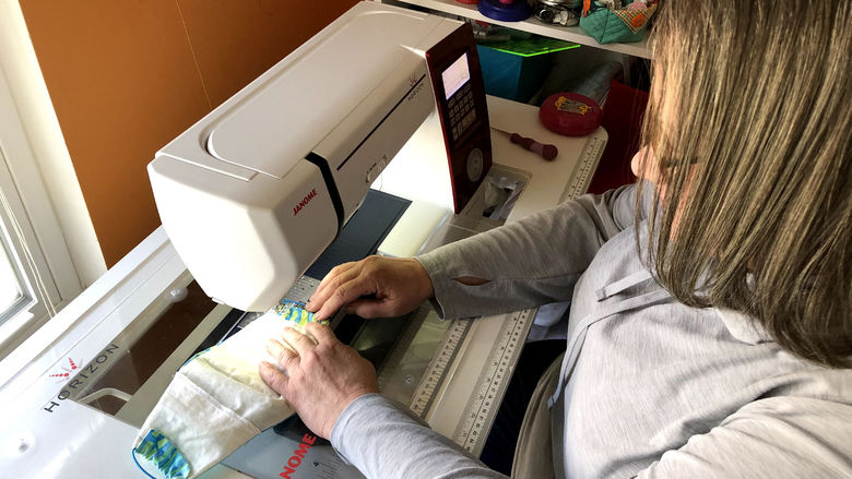 Laura Molen, Brandywine adjunct instructor, making a mask. 