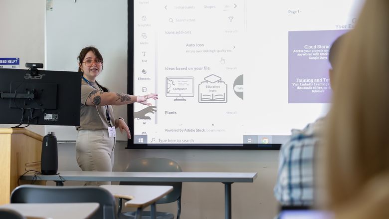 woman speaking and pointing at projector