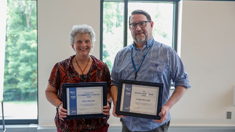 two people holding certificates