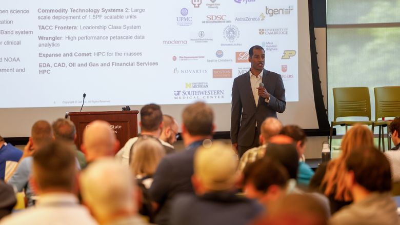 man speaking in front of crowd