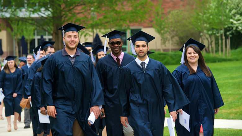 Gradutes walking to commencemnet 