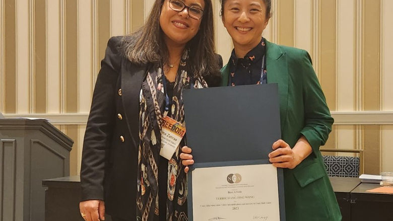 Terrie Wong holding certificate next to woman at National Communication Association conference
