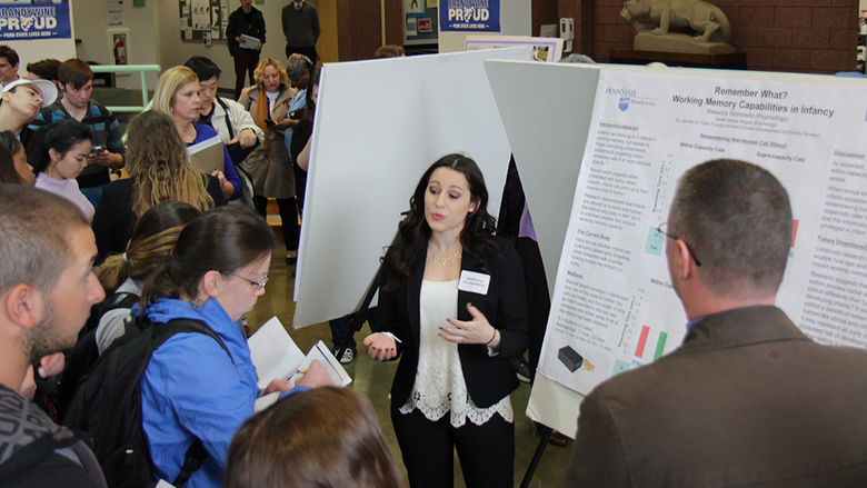 Students discuss their research at a symposium.