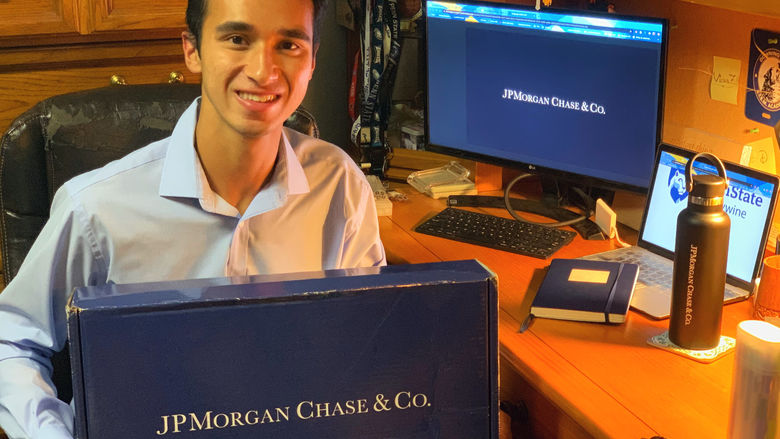 Victor Ficarra holds his welcome package from J.P. Morgan. 