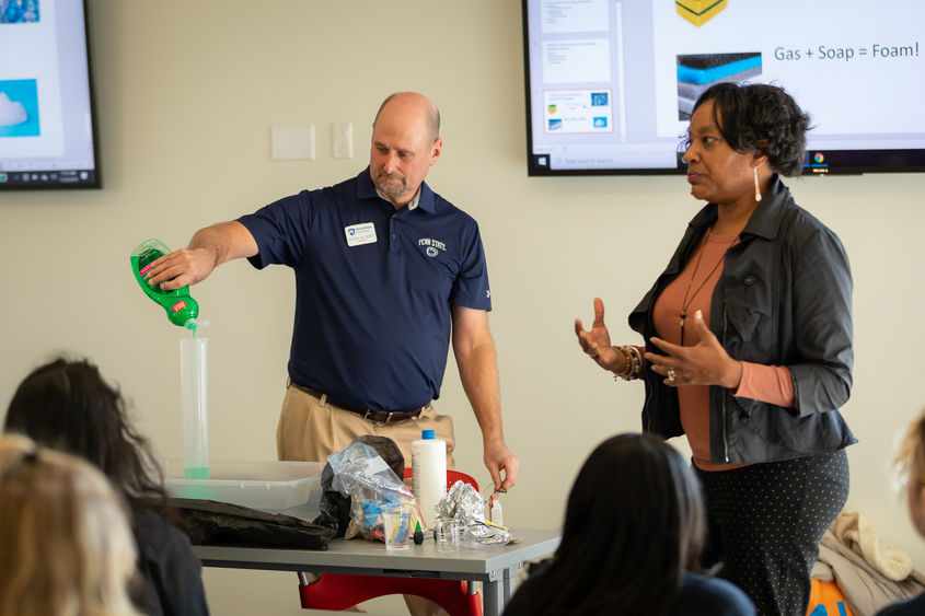 Penn State Brandywine faculty conduct a chemistry experiment for high school girls.