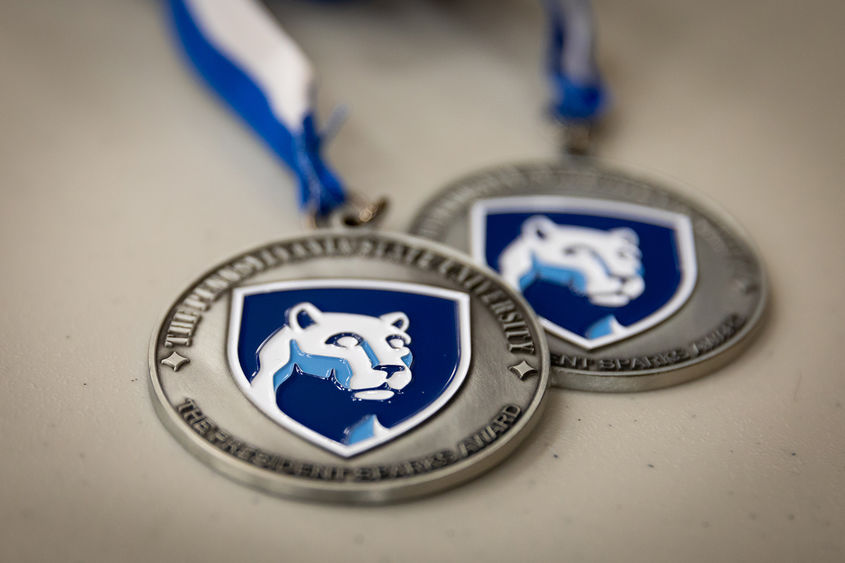 Penn State academic achievement medals.