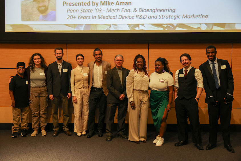 nine startup business owners smiling after pitch competition