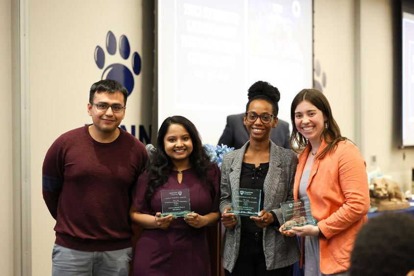 Three women accepting awards from a man