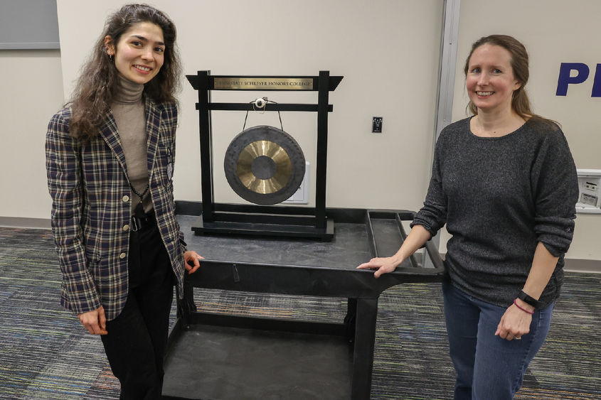 Anna and Nora standing with a gong