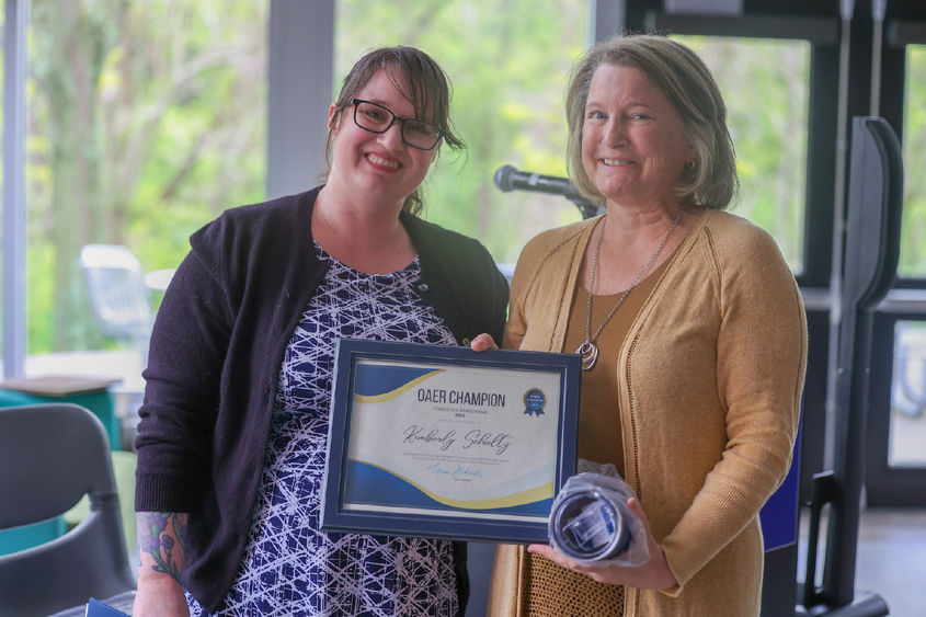 two women holding certificate