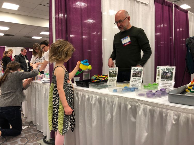 Mark Boudreau teaches a child about the environment.