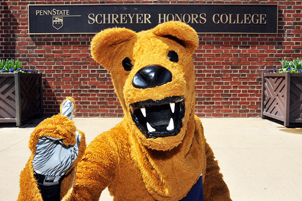 Nittany Lion mascot in front of Schreyer Honors College