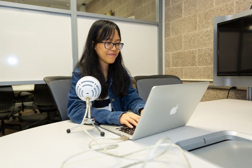 Anna Nguyen at Penn State Brandywine in front of a laptop. 