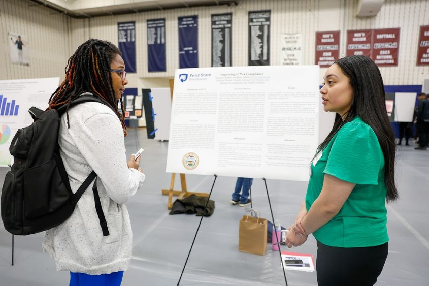student presenting her internship work to a professor