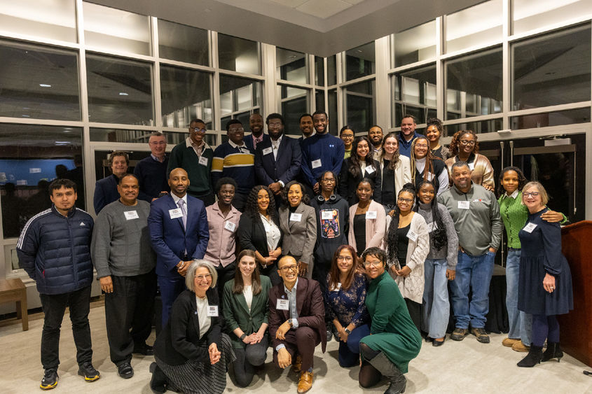 A large group of people gather for a photo at an event