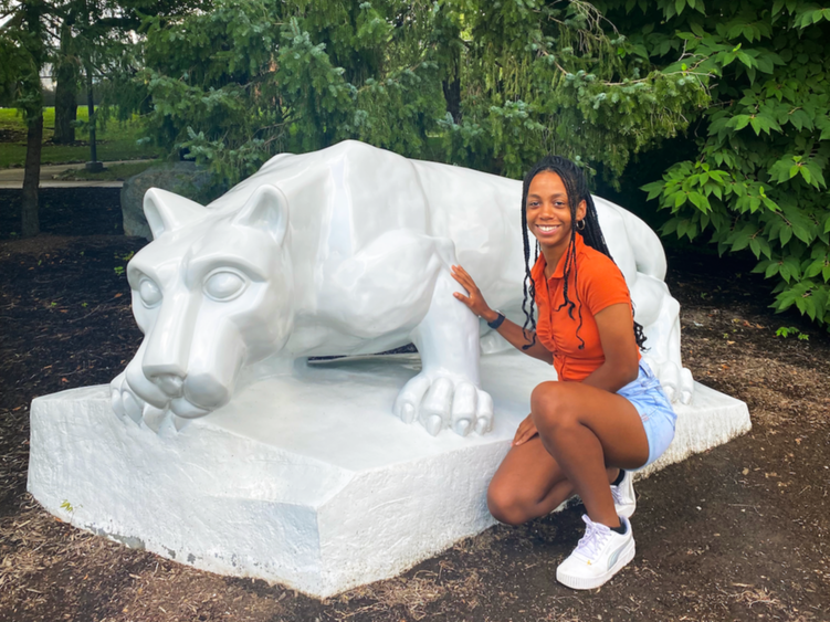 Angel Asomugha next to the Lion Shrine at Penn State Brandywine