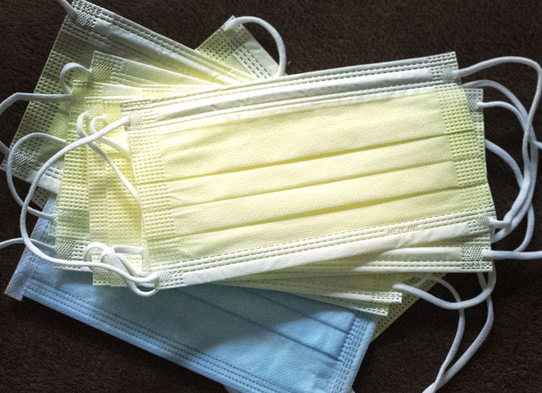 Covid masks A stack of blue and yellow face masks.