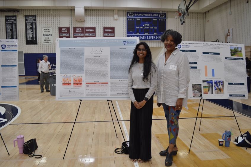 student and professor with poster