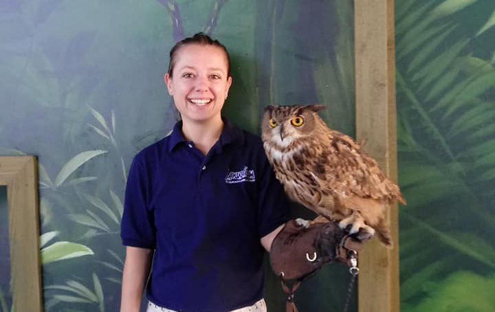 Penn State alumna Dana Piatt, who works as an animal trainer, holding an owl.
