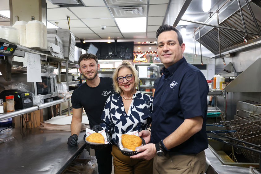 Marilyn and two epic double decker employees holding inside-outs, one of the restaurant's signature dishes