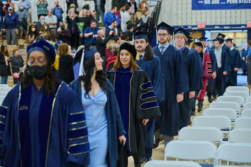 Students and professors walk into the campus gym.