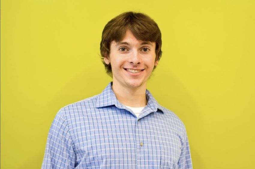 Man standing in front of bright yellow background