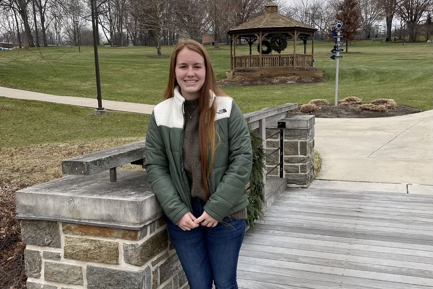 Student standing on bridge on the Penn State Brandywine campus.