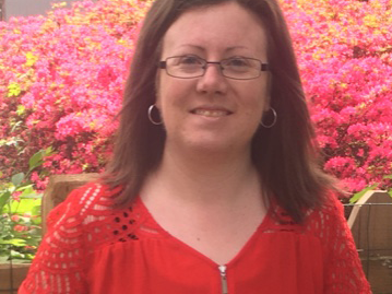 Lauren Jerla smiling in front of flowers