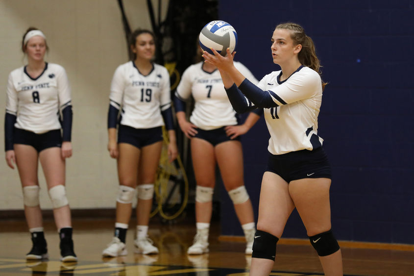 Penn State Brandywine first-year student Lexie Berry prepares to serve during a volleyball match.