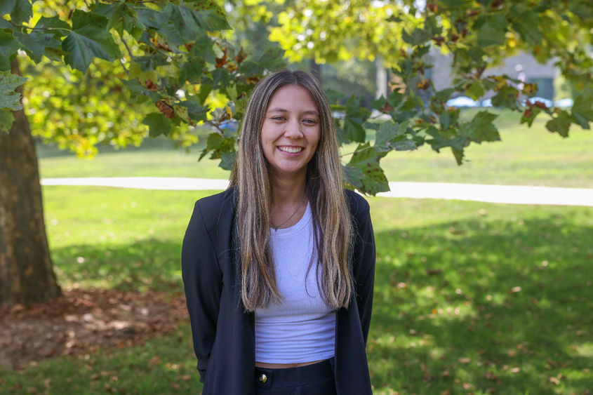 Madison Ollis standing in front of tree