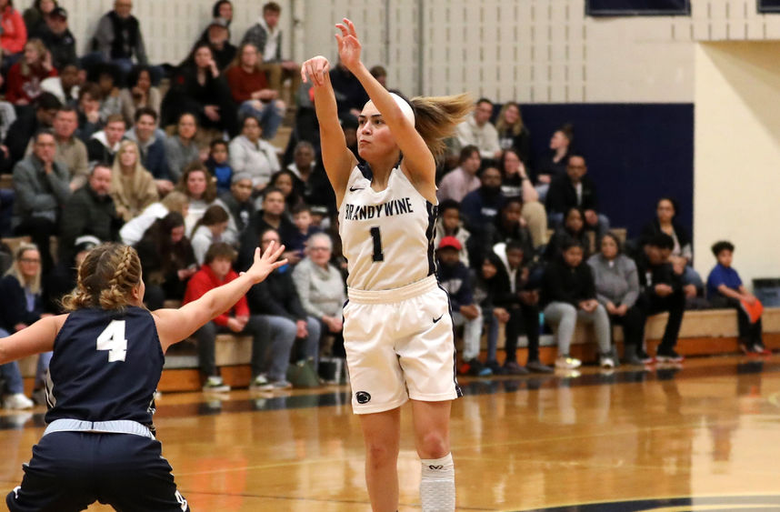 Nikki Velez sinks a three-pointer over the out-stretched arm of a defender