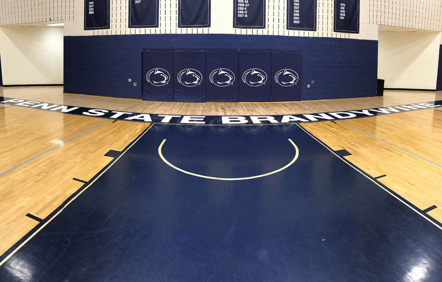 Penn State Brandywine gym floor showing Penn State athletics logos.