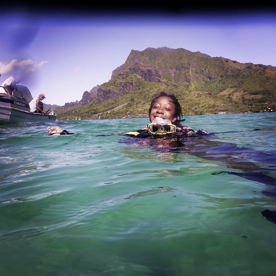 Camille smiling in the ocean wearing scuba gear