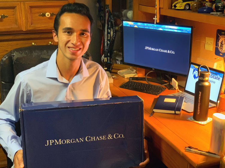 Victor Ficarra holds his welcome package from J.P. Morgan. 