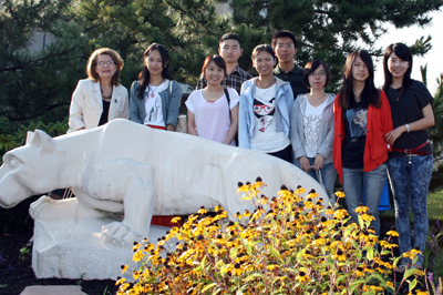 Lynn Hartle standing with her class by the Lion Shrine