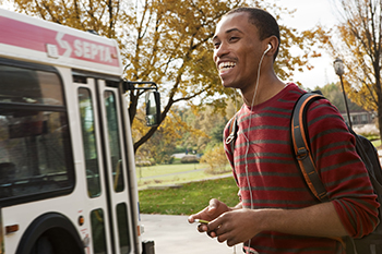 student at bus stop